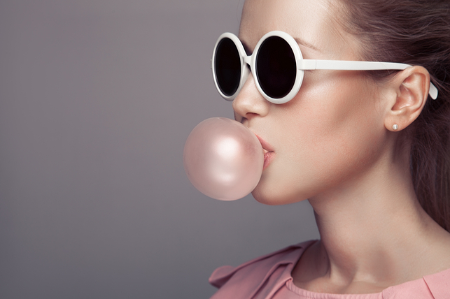 woman blowing a gum bubble