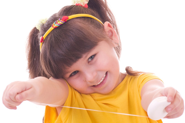 smiling child taking out dental floss