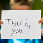 child holding a thank you sign 4