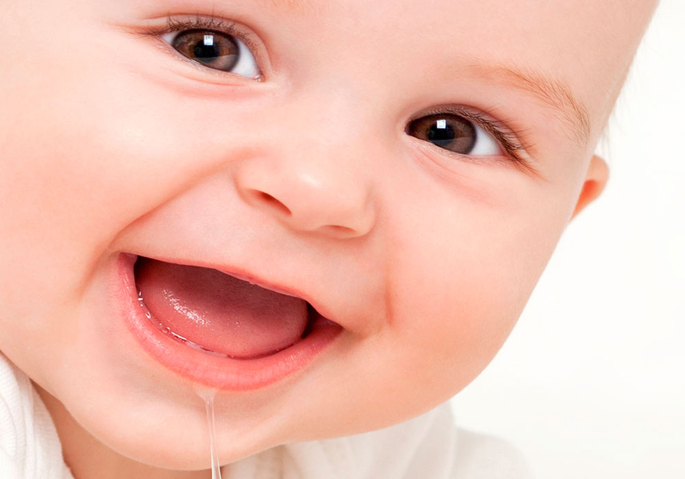 close up of smiling drooling baby
