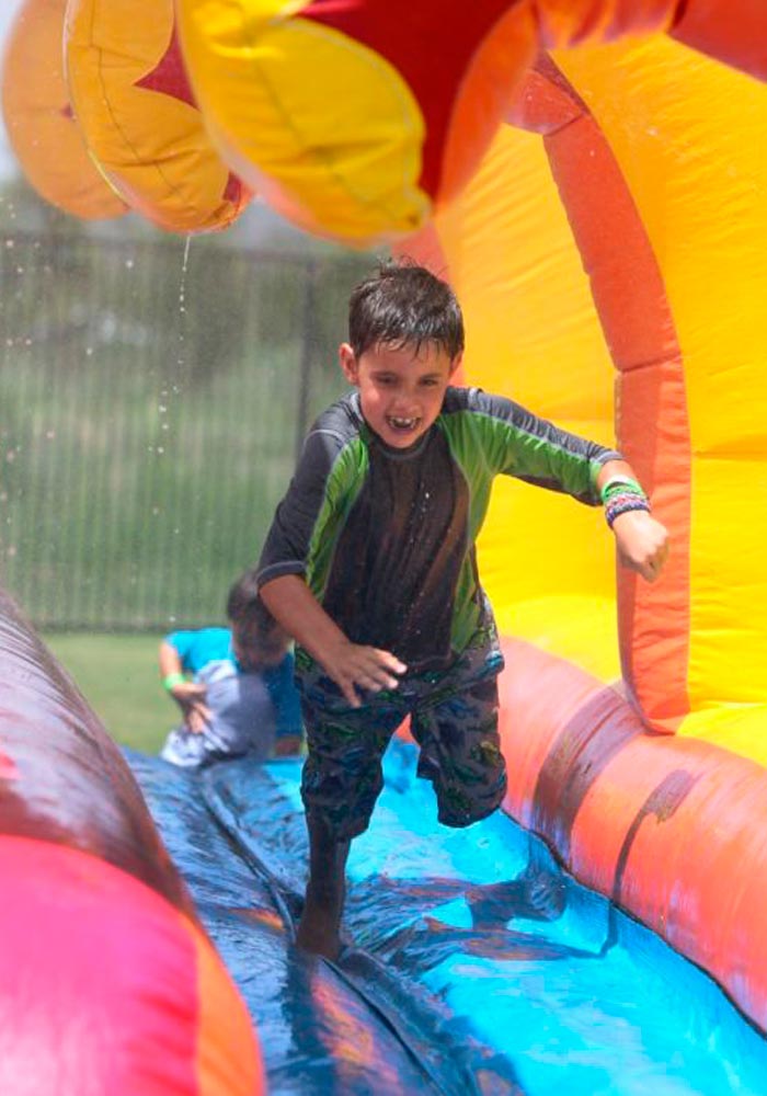 Child playing in inflatable water bounce house