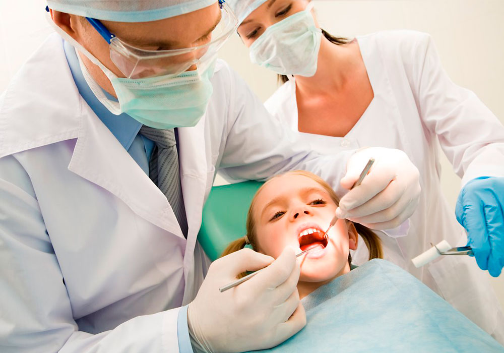 child getting cleaning by dentists